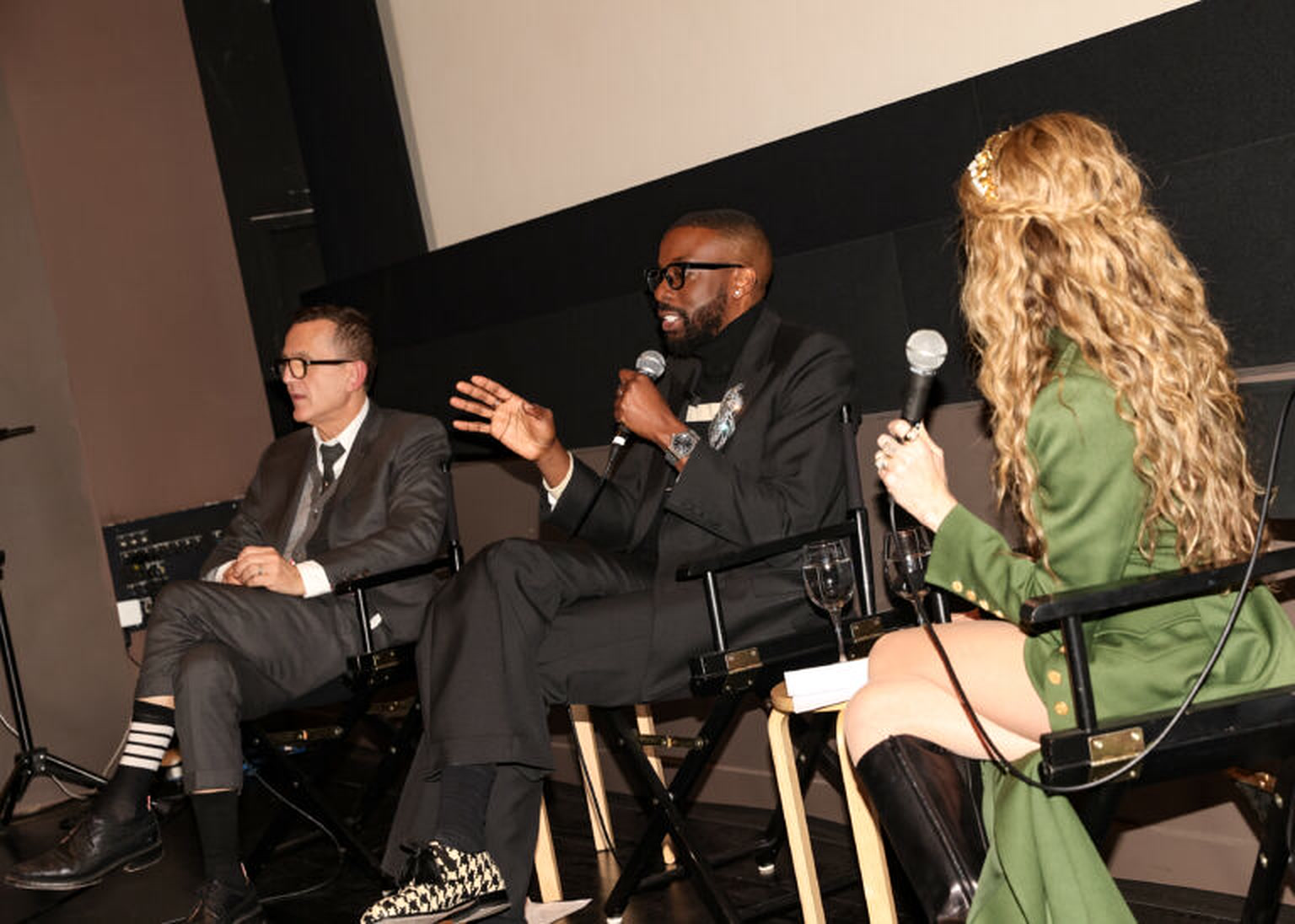 John Imah speaking on a panel alongside other speakers and a moderator