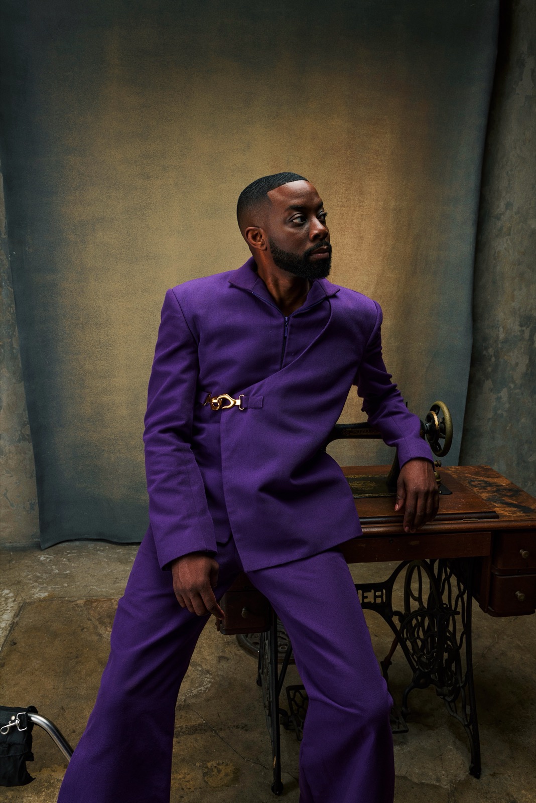 John Imah standing in a purple suit