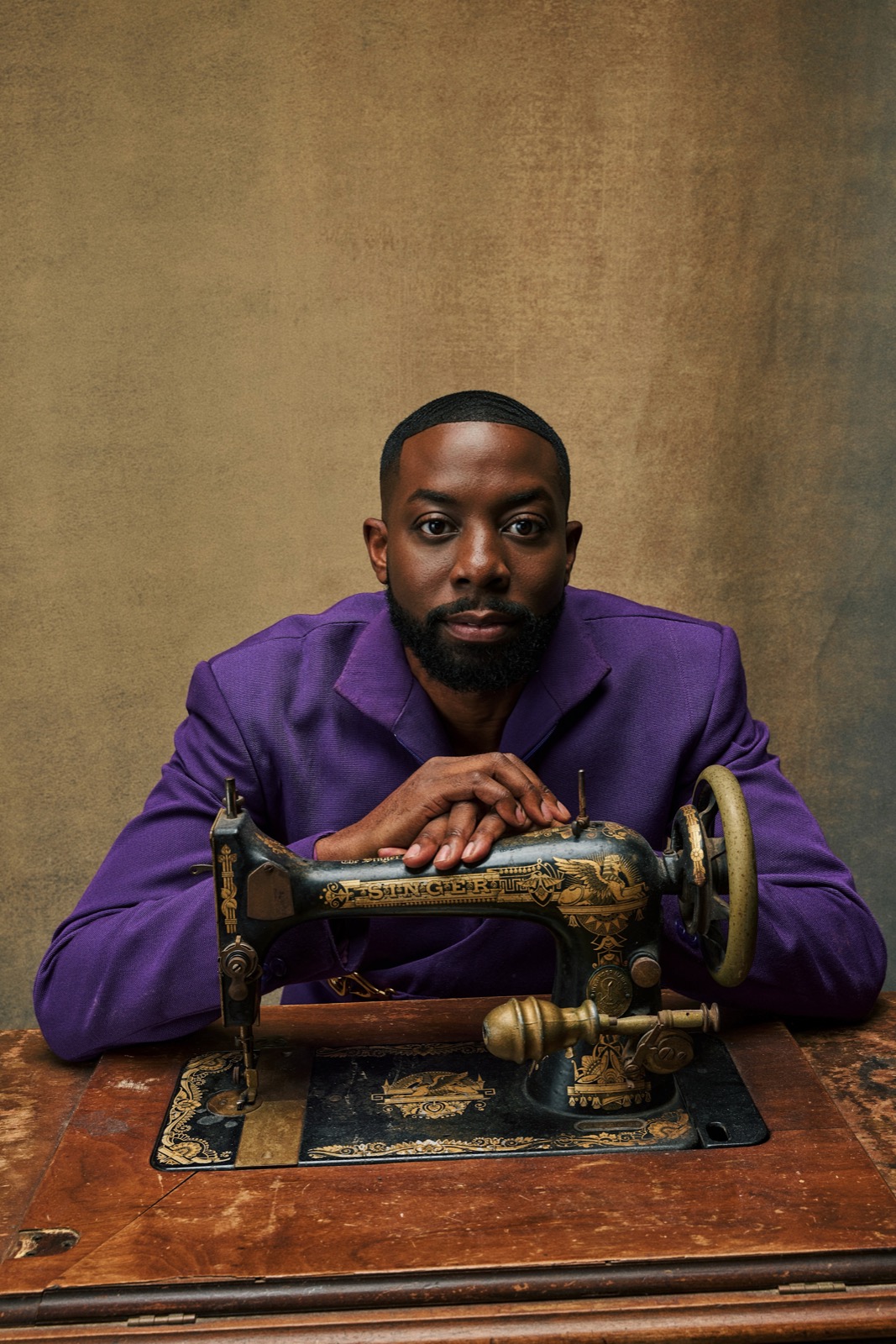 John Imah photographed with a sewing machine