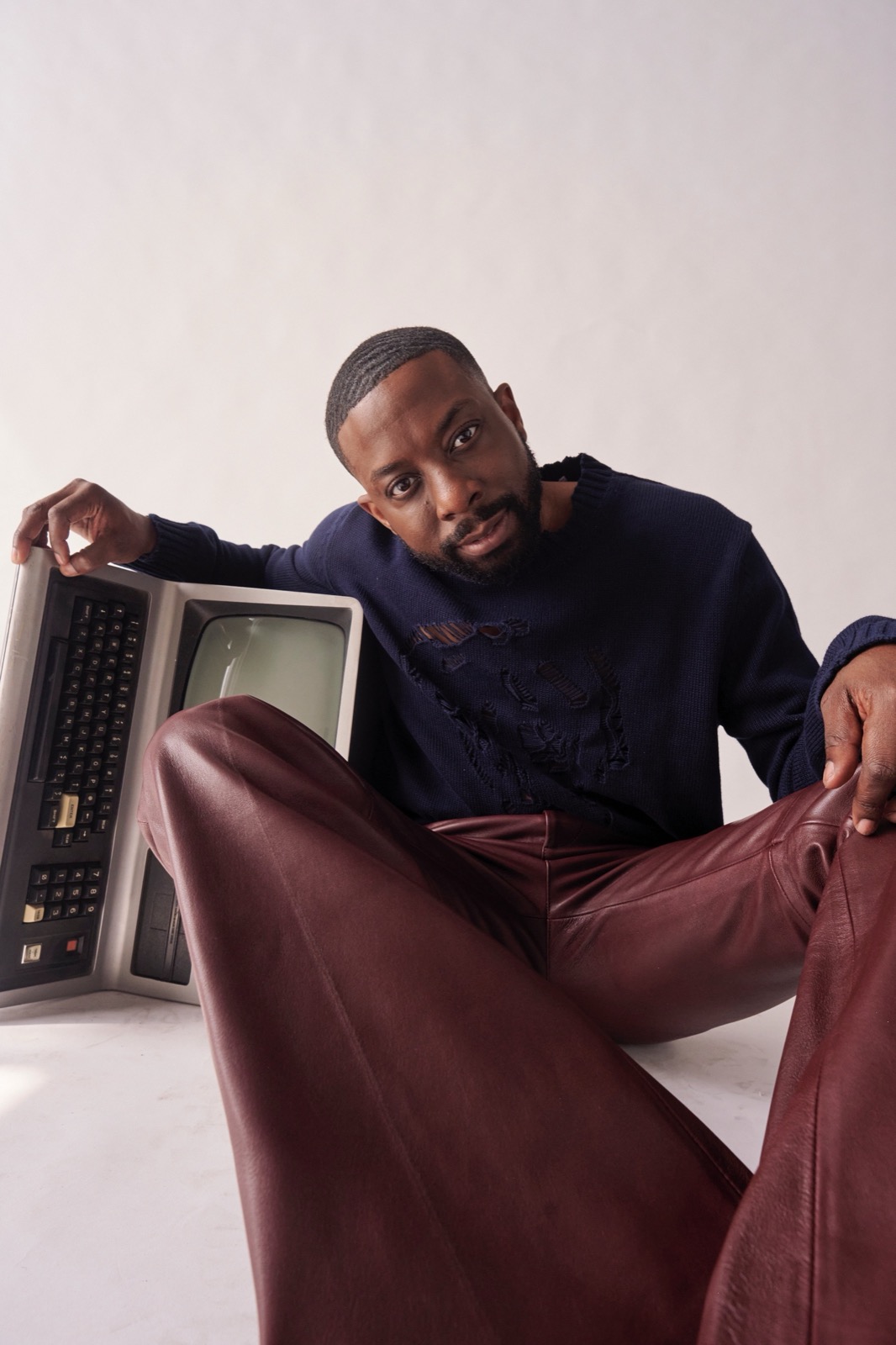 John Imah seated beside a vintage computer